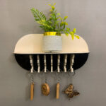 Close up of hooks and shelf in MDF wall key holder