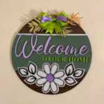 Close-up of floral welcome wooden sign board detailing