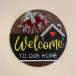 Welcome sign with artificial flowers and ribbons
