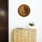 Decorative acrylic mirror wall clock displayed in living room interior